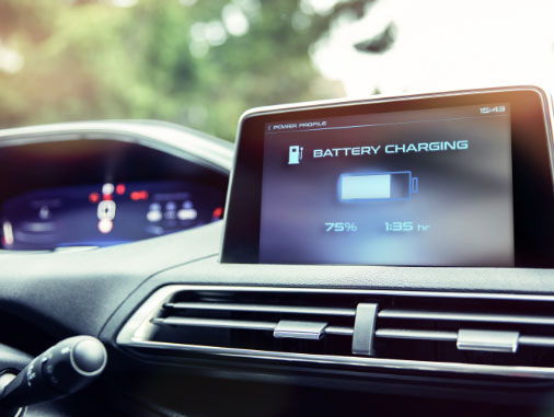 An image of a screen on a car dashboard showing a battery charging status.